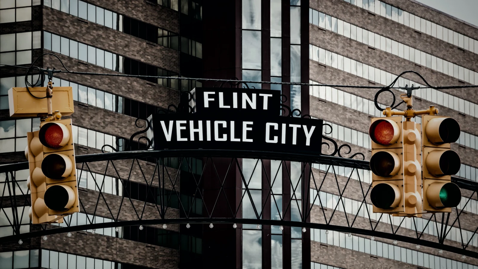 The Flint Vehicle City sign above a downtown street